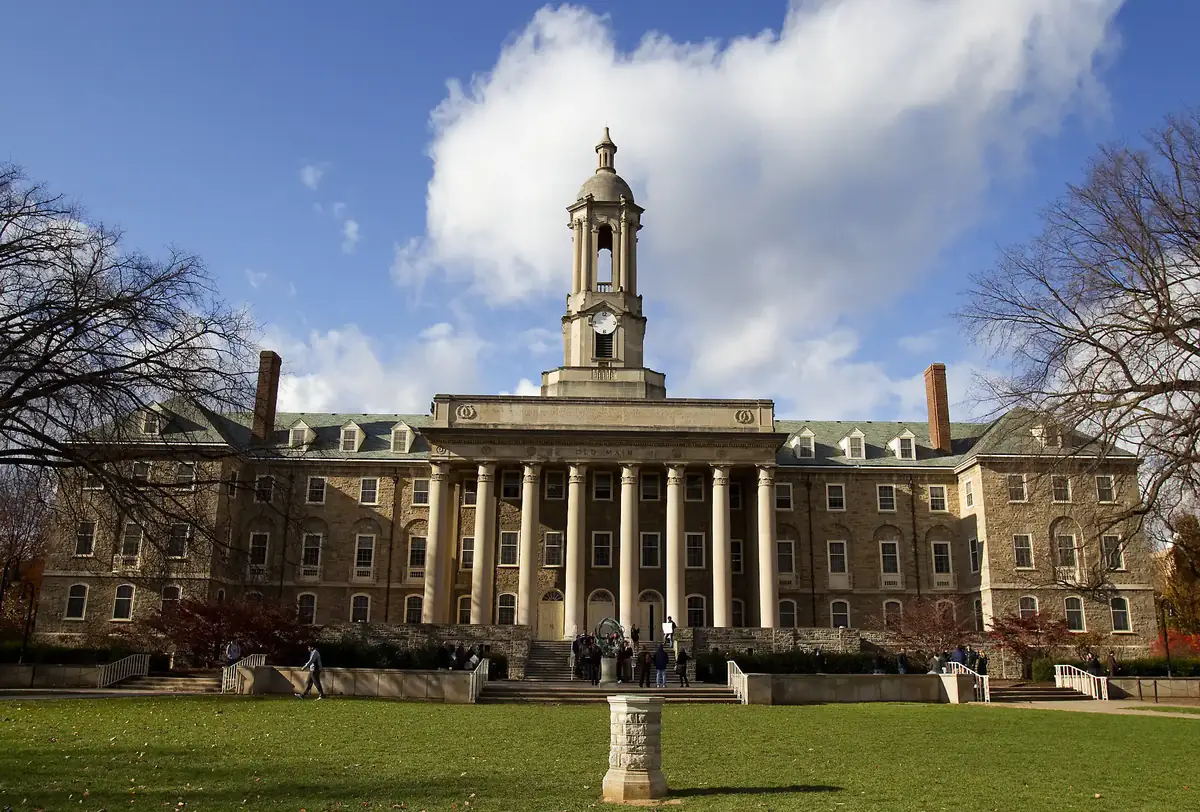 Old Main at Penn State under a bright sky